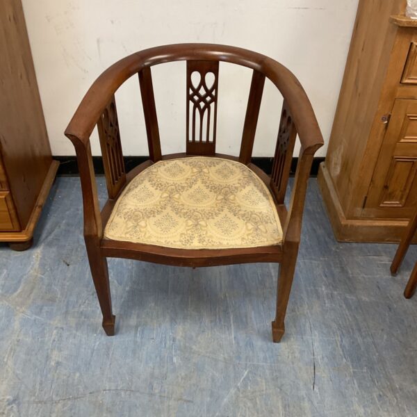 Antique Edwardian mahogany tub chair with floral upholstery.