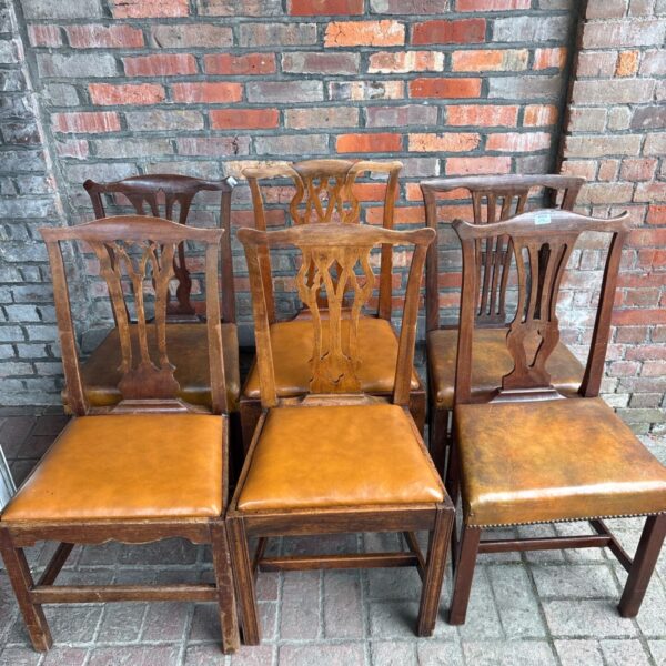 Set of six Edwardian oak dining chairs with leather seats.