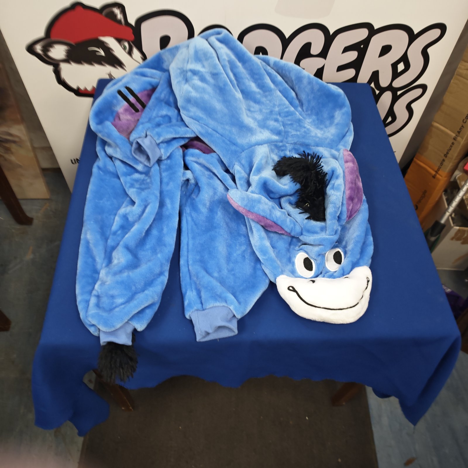 Blue Eeyore style onesie, size M, soft plush material.
