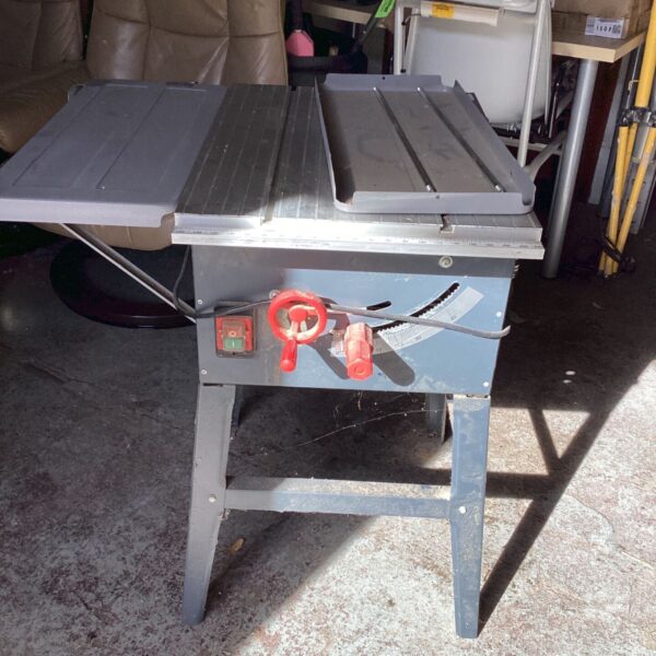 Vintage electric table saw with metal frame and tilting blade.