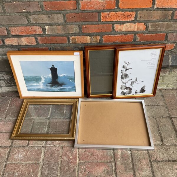 Lot of five vintage empty picture frames in gold tones.