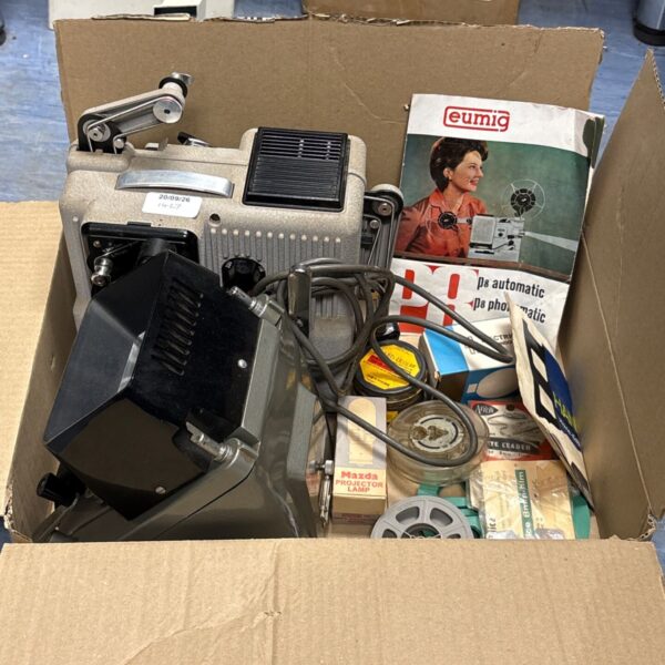 Vintage Eumig PA Automatic film projector with accessories for 8mm movies.