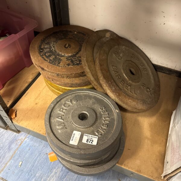 Vintage Marcy iron exercise weight plates for gym use.