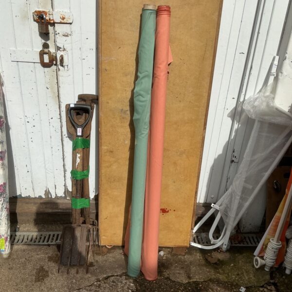 Vintage green and pink fabric rolls for crafting projects.