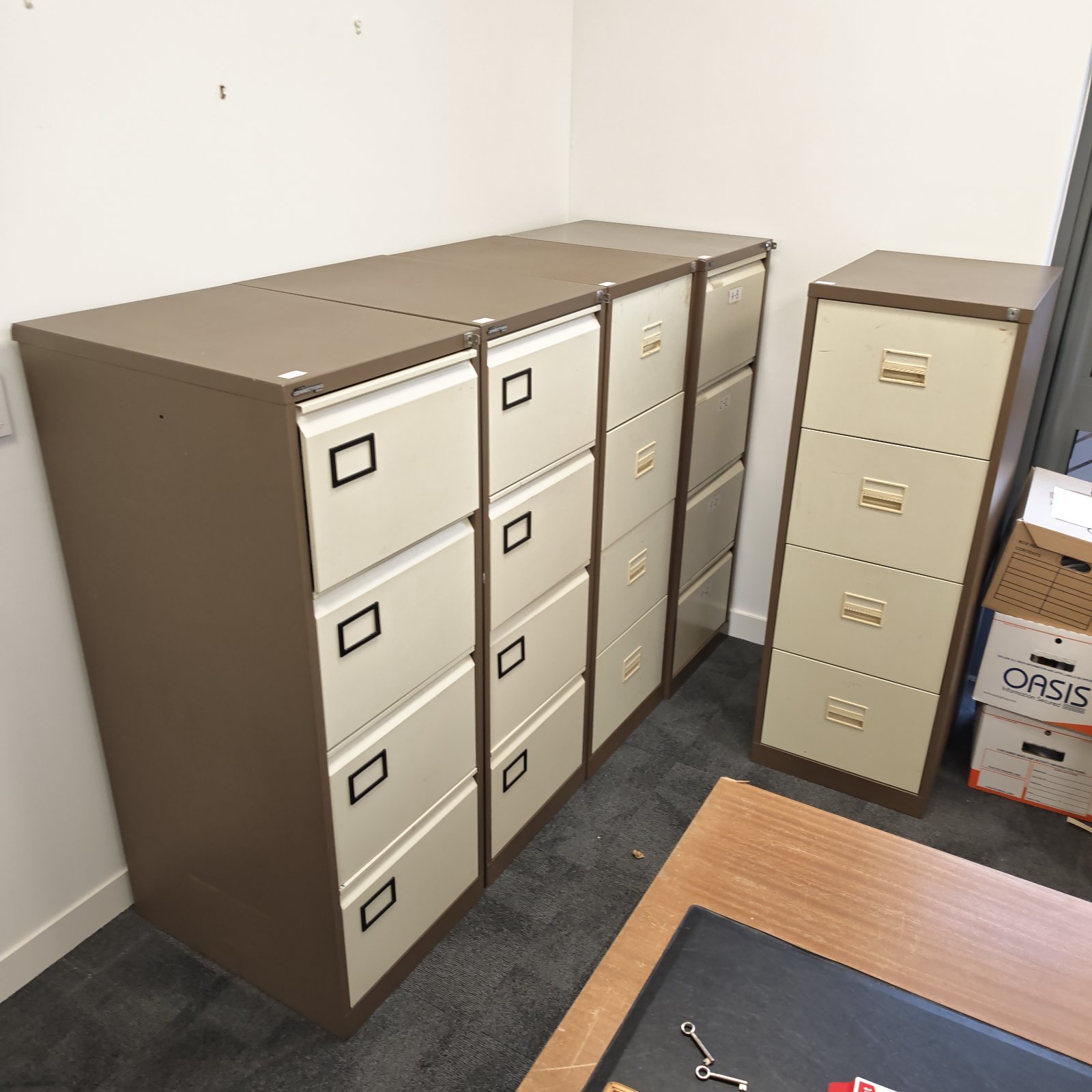 Five grey filing cabinets for office document storage.