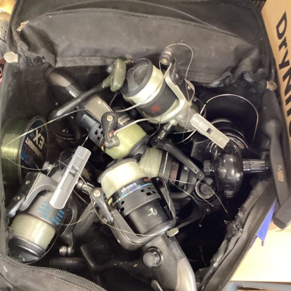 Lot of used fishing reels including an Okuma reel.