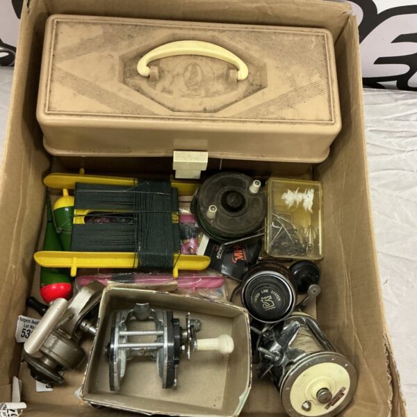 Vintage fishing tackle lot with reels and a plastic tackle box.
