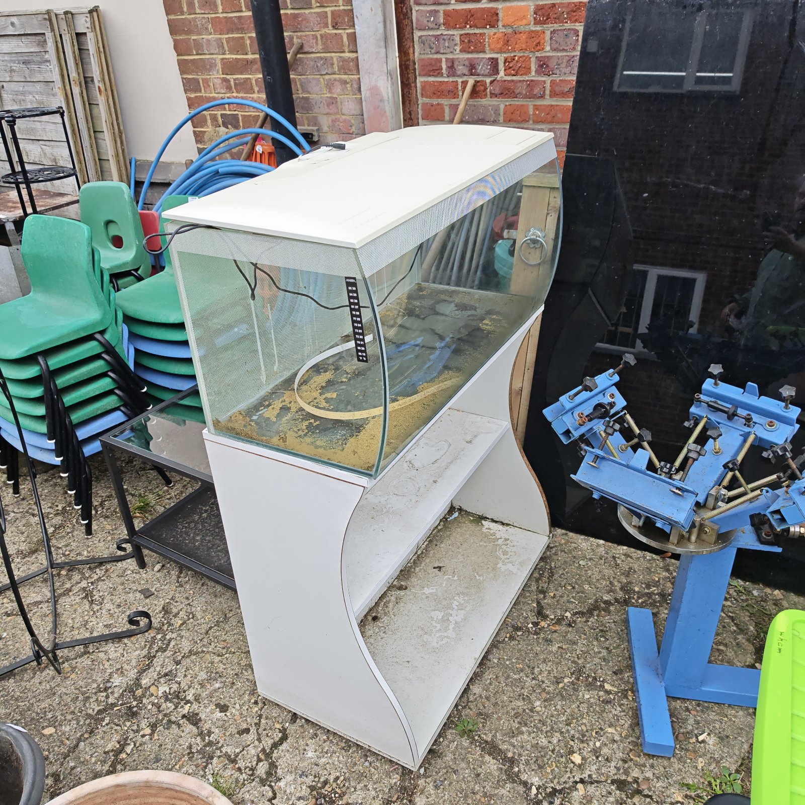 Vintage Fluval fish tank with white base, showing signs of age.