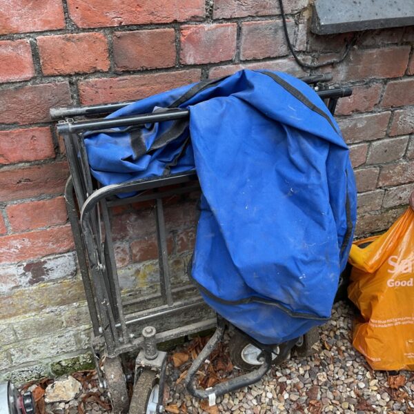 Vintage folding blue trolley with metal frame and canvas.