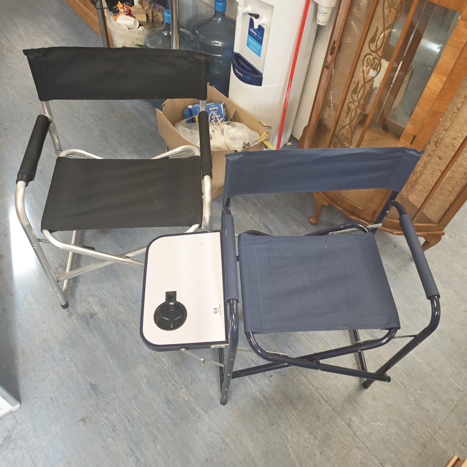 Blue folding camping chair with a side table for outdoor use.