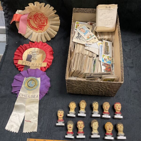 Vintage football rosettes, figures, and cigarette cards collection.