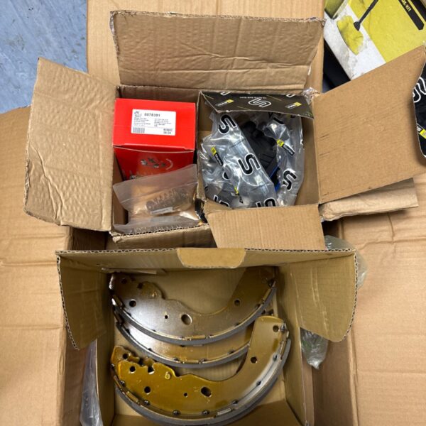 Box of new Ford Ranger parts including brake shoes and wheel cylinder.