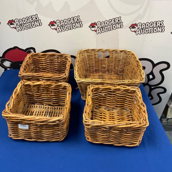 Four vintage wicker baskets stacked, ideal for rustic home storage.