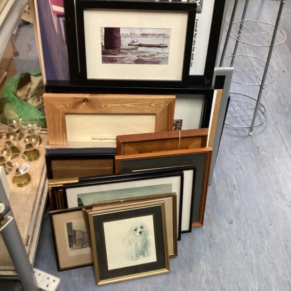 Assorted framed artworks and pictures in a large collection.
