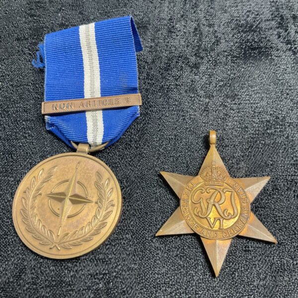 Military medals including the France and Germany Star and UN Balkans medal.