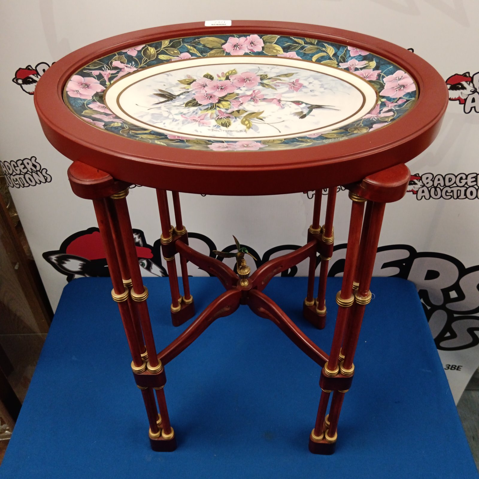 Close-up of Franklin Mint hummingbird table with floral plate.