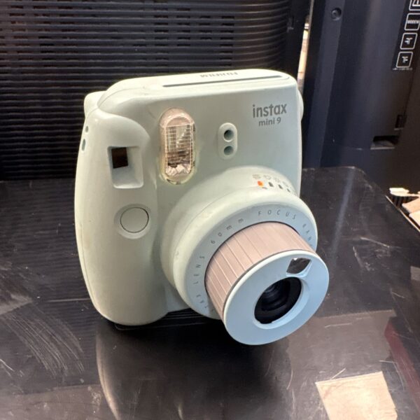 Pink Fujifilm Instax Mini 9 instant camera, retro style.