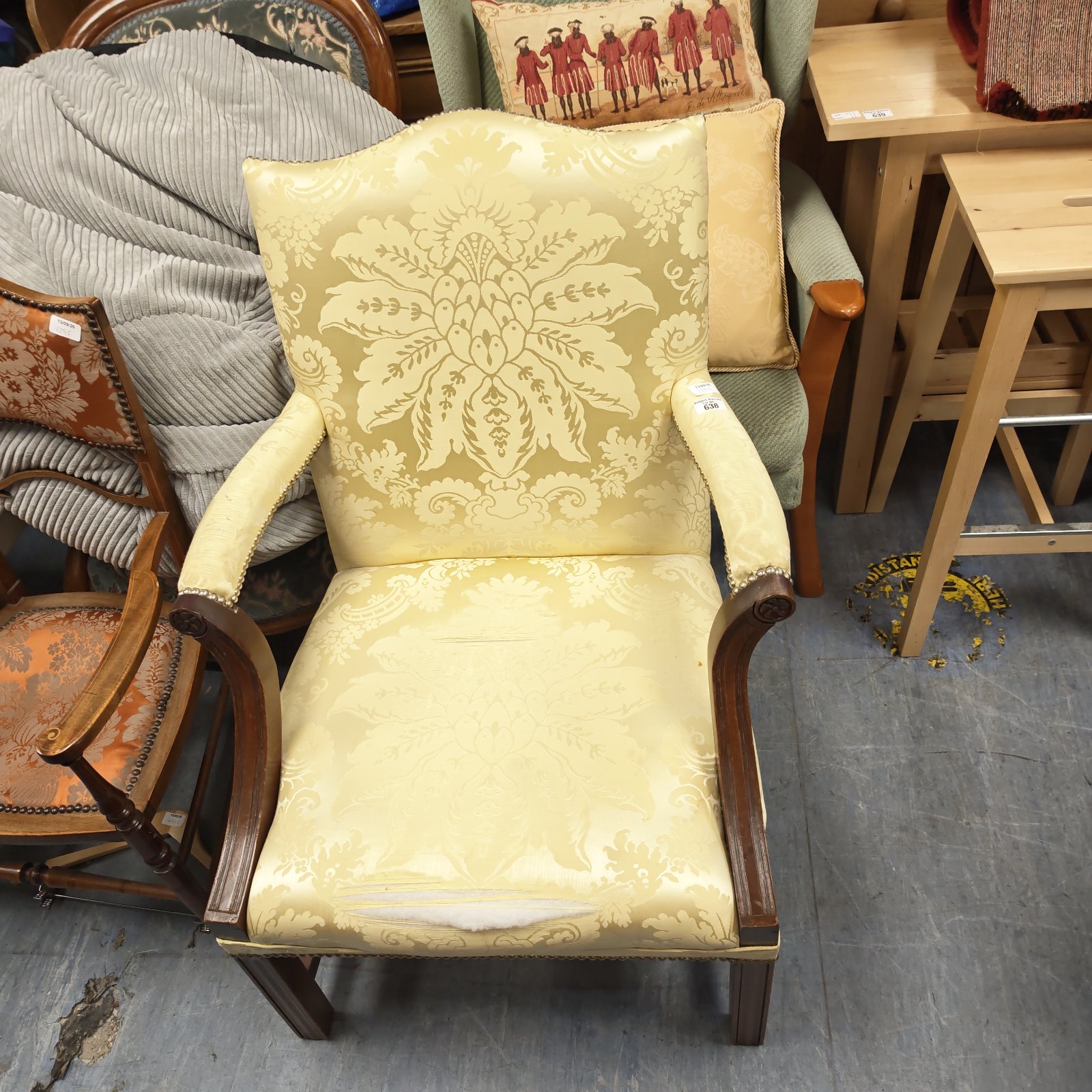 Yellow floral damask Gainsborough armchair with a noticeable tear.