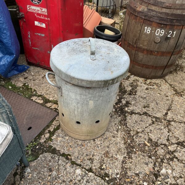 Vintage galvanised incinerator for burning garden waste outdoors.