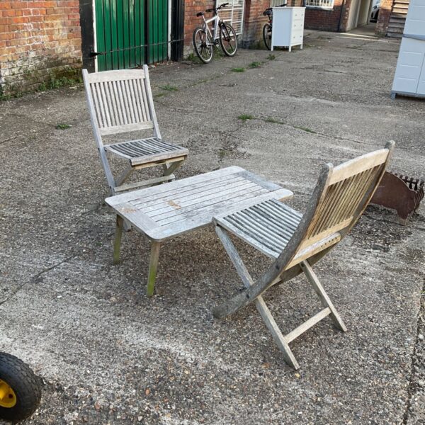 Vintage hardwood garden furniture set with folding chairs and table.