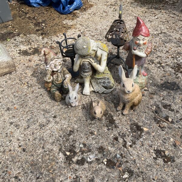 Collection of garden ornaments including rabbits and a Buddha statue.