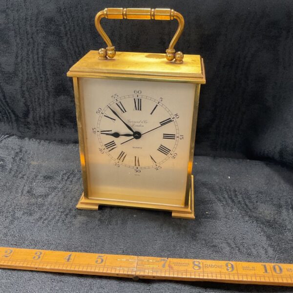 Antique brass carriage clock by Garrard & Co, London, with enamel dial.