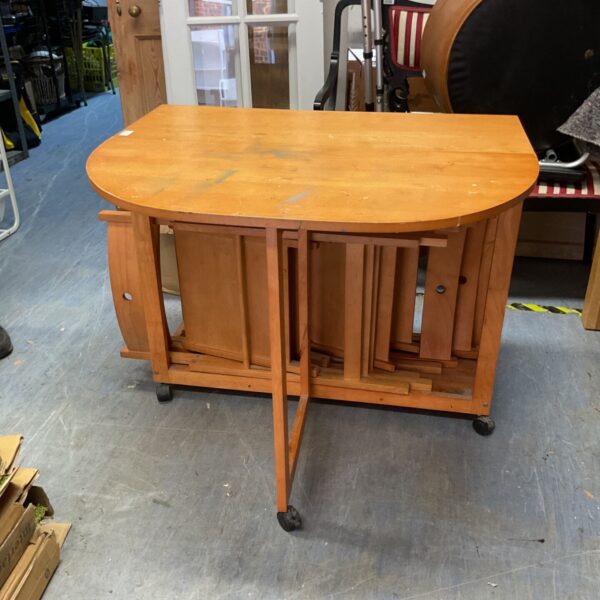 Vintage gate leg table with four chairs in a room setting.