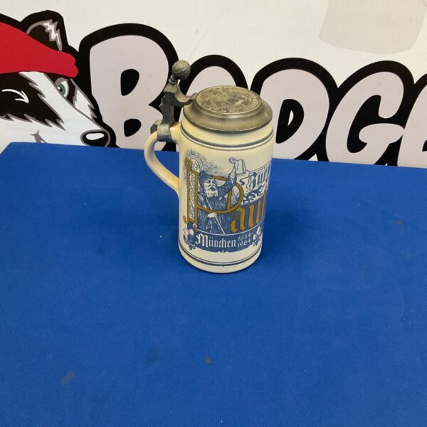 Vintage German beer stein with Bavarian scene and pewter lid.