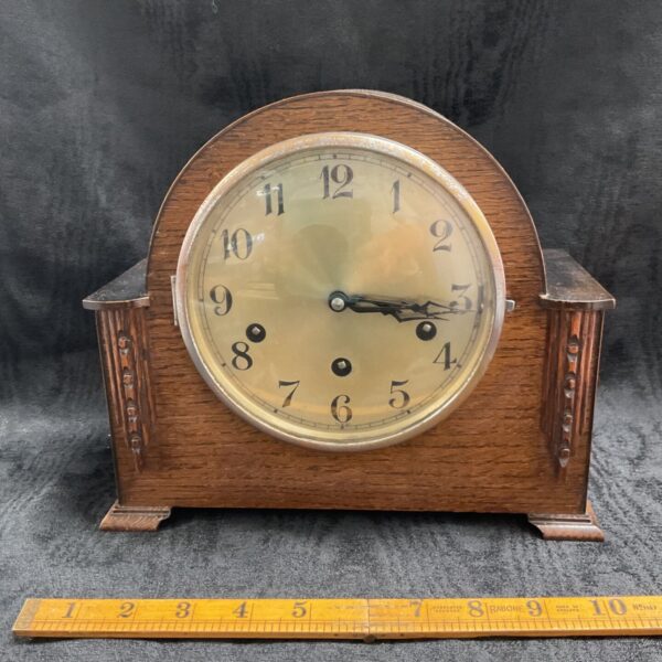 Vintage German Gufa mantle clock with oak case and dial.