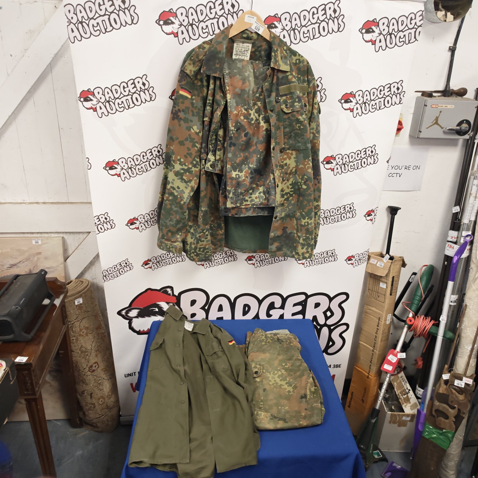 German military camouflage jacket and trousers at auction.