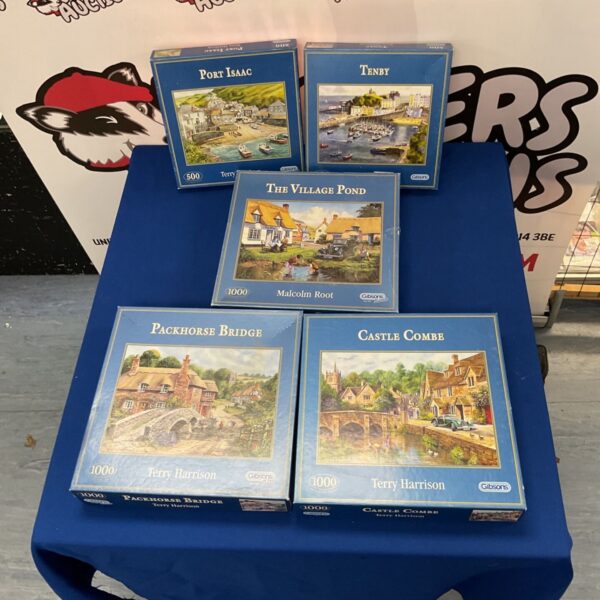 Lot of five vintage Gibsons jigsaw puzzles with scenic artwork.