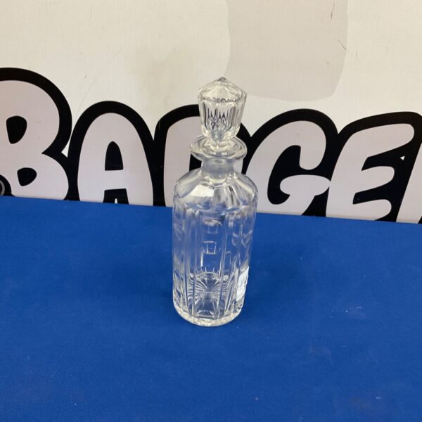Vintage glass decanter with decorative stopper, clear crystal design.