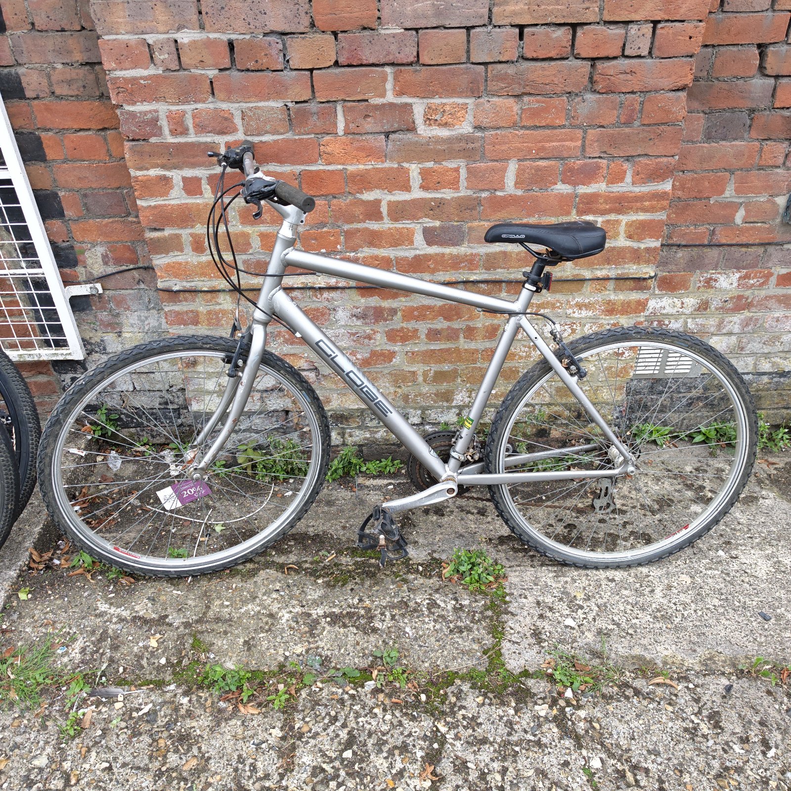 Silver Globe Pish mountain bike with upright handlebars.