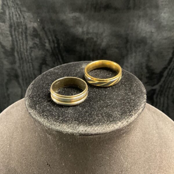 Pair of vintage gold tone rings, sizes X and T.