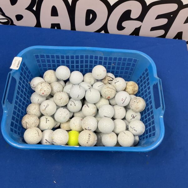 Basket of used golf balls including Titleist brand.