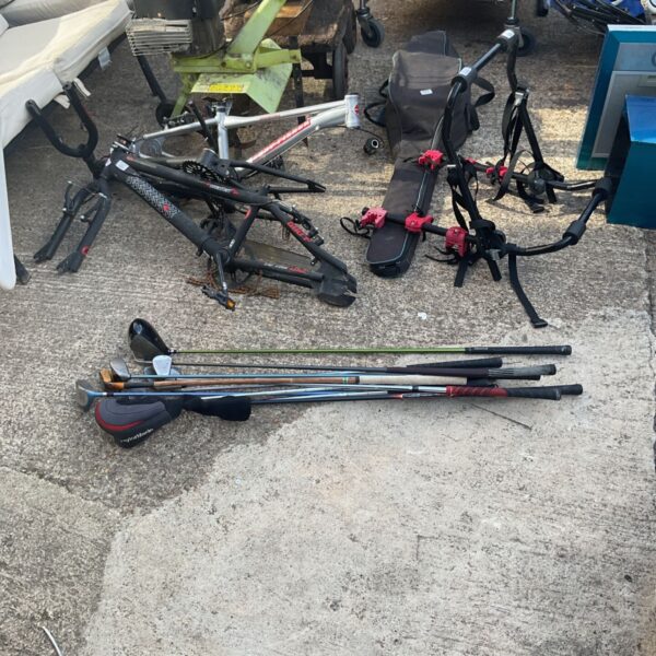 Collection of used golf clubs including a Taylormade driver.