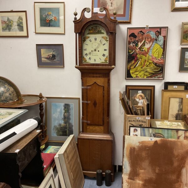 Antique grandfather clock with painted dial and weights.