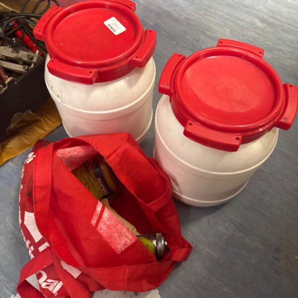 Vintage grease gun and watertight containers for automotive storage.