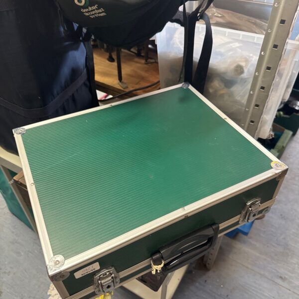 Green flight case with keys, ideal for equipment protection.