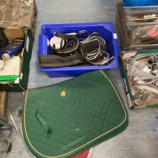 Green horse saddle pad showing signs of wear and use.