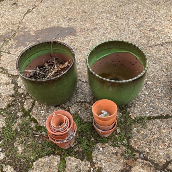 Collection of green garden planters and terracotta pots for outdoor use.