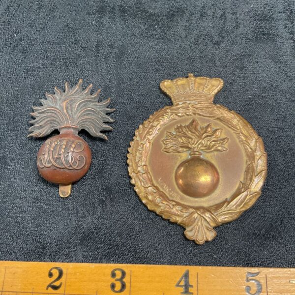 Antique brass HAC cap badge with flaming grenade design.