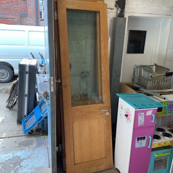 Half glazed office door measuring 220cm, showing signs of wear.