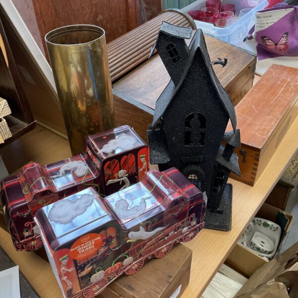 Vintage Halloween haunted house and glow-in-the-dark ghost train tins.