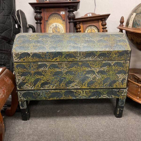 Antique hand-painted chest with a repeating cat pattern.