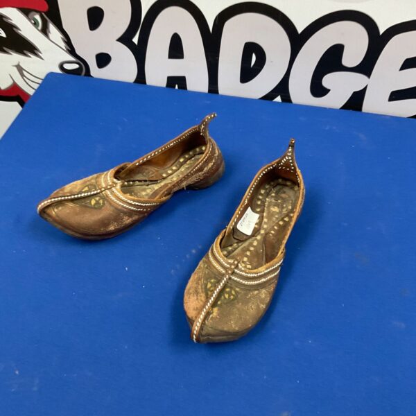 Intricate embroidery on handmade leather shoes, traditional ethnic footwear.