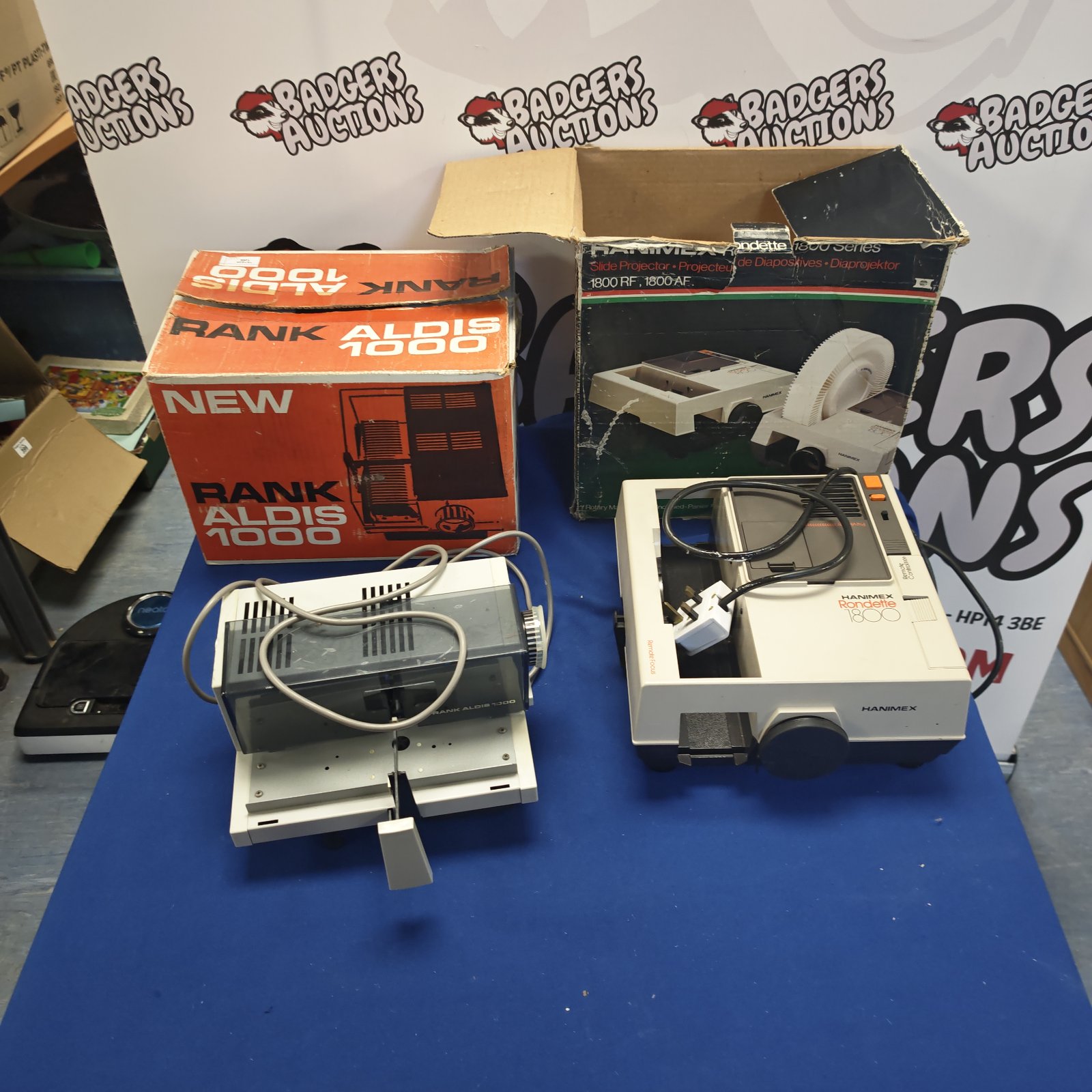 Vintage Hanimex and Rank Aldis 1000 slide projectors with boxes.