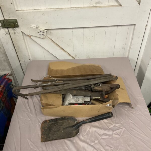 Assorted hardware tools including crowbars and files in a box.
