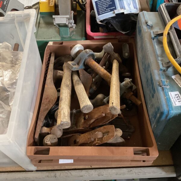 Assorted hammers and hardware tools in a box.