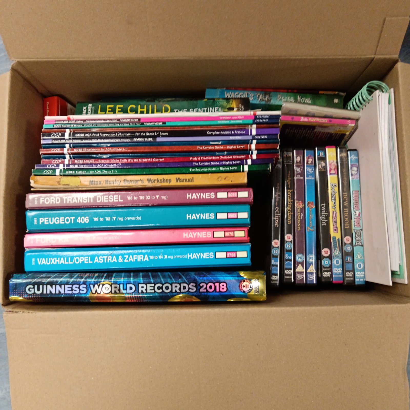 Mixed lot of Haynes manuals, revision books, and DVDs for automotive and educational purposes.
